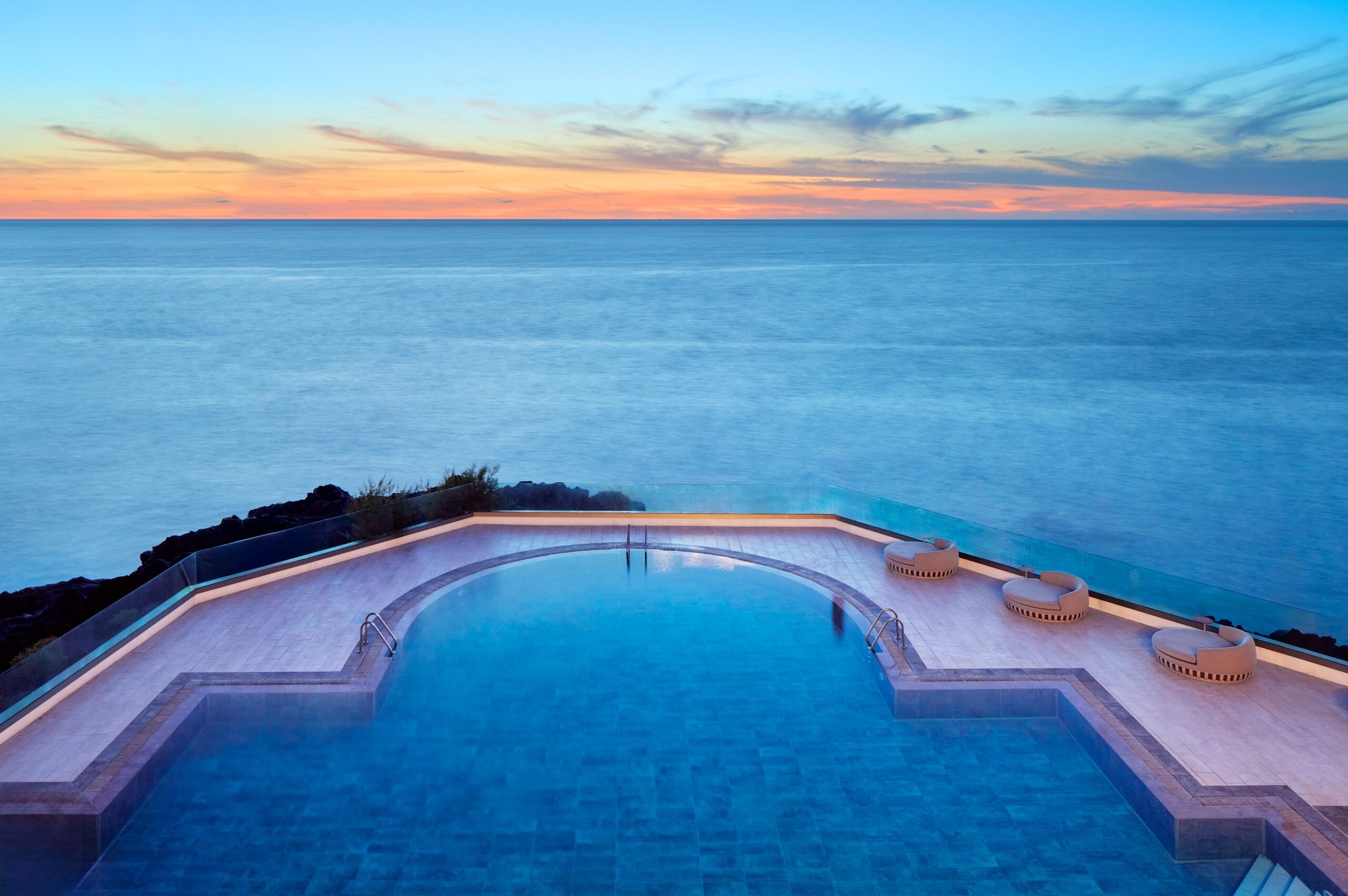 Infinity pool overlooking the sea at dusk